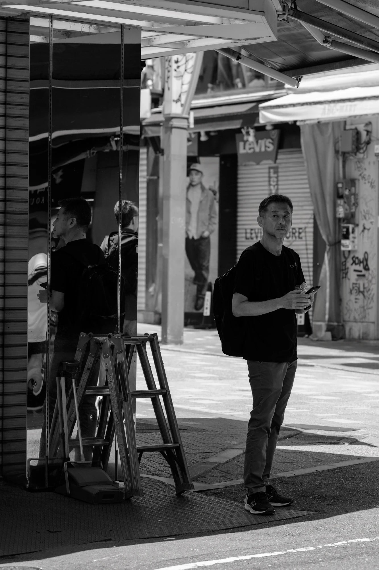 man and reflection captured in my Candid photography masterclass Japan